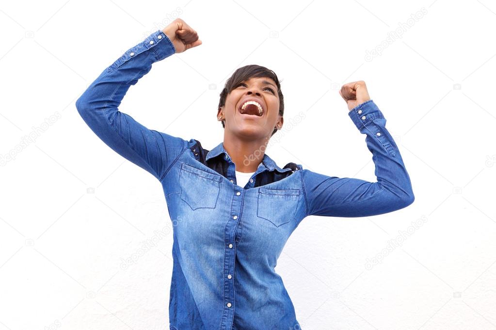 Young african american woman cheering with arms raised
