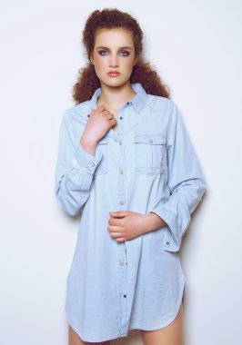 Elegant female fashion model posing in denim shirt