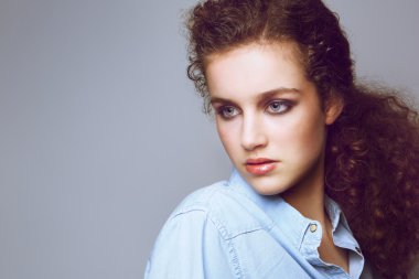Attractive young fashion model with curly hair