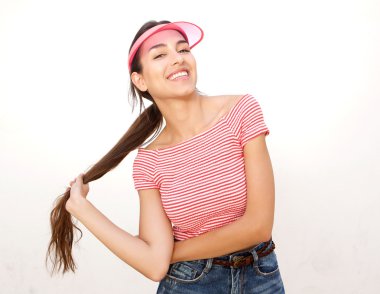 Cool modern girl smiling with long hair and cap