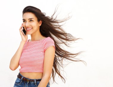 Smiling young female talking on cell phone