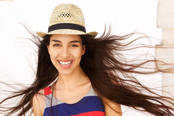 Carefree young woman with long hair blowing in the wind — Stock Photo, Image