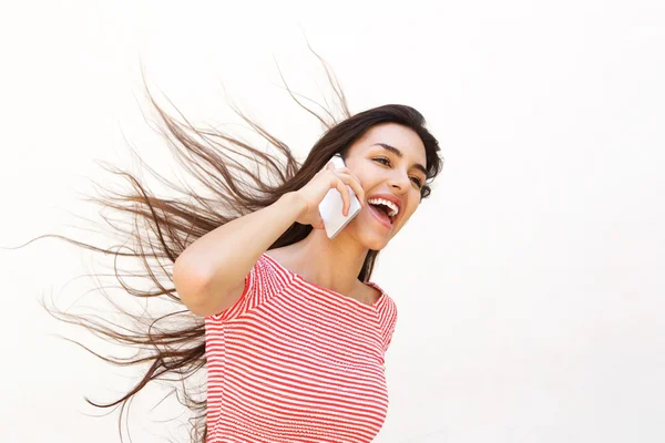 Teenager talking on mobile phone with wind blowing hair — Stockfoto