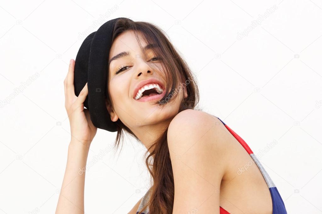 Cute girl with hat laughing against white background