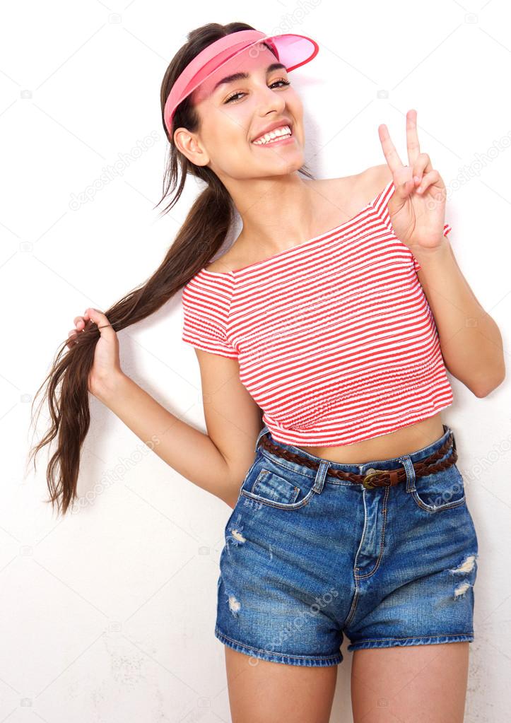 Beautiful girl smiling with peace hand sign 