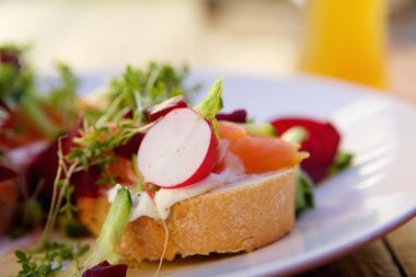 Fresh salad with smoked salmon on bread