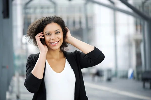 Attrayant afro-américaine femme d'affaires souriant avec téléphone portable — Photo