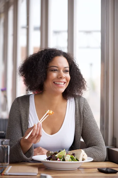 African american young woman sitting at cafe eating salad — Stock Photo, Image