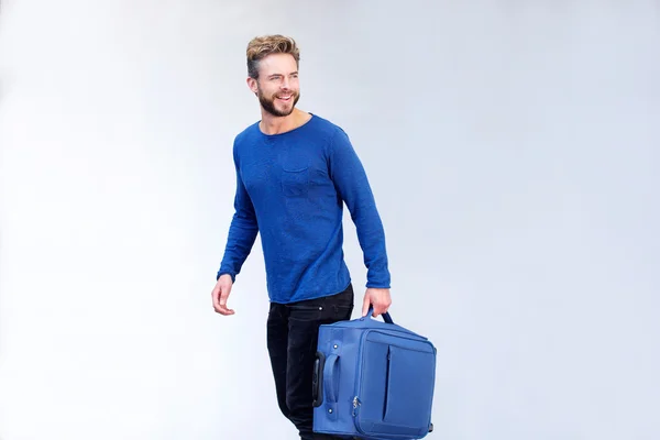 Handsome traveling man with suitcase smiling — Stock Photo, Image