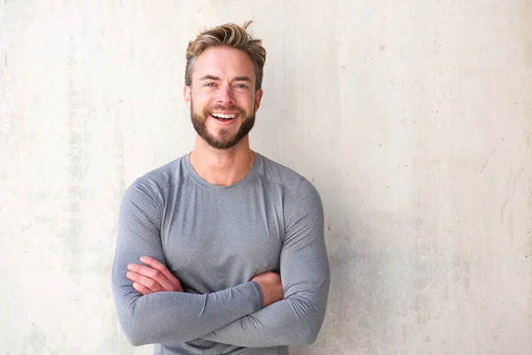 Smiling cool guy with arms crossed — Stock Photo, Image