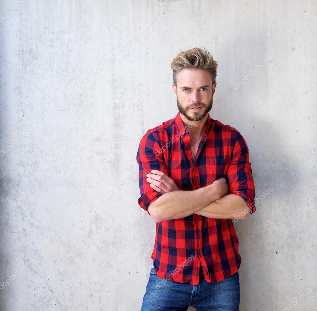 Handsome casual man with beard posing with arms crossed