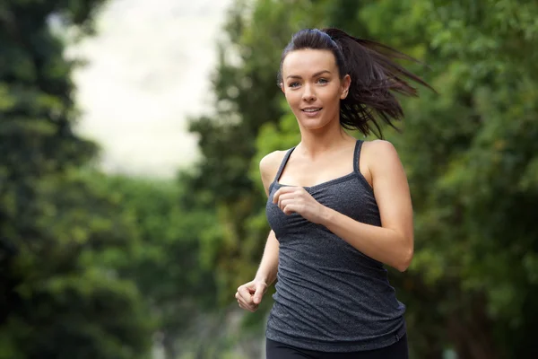 Active woman running outdoors — Stock Photo, Image