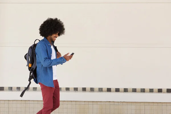 Homme étudiant marchant avec sac et téléphone portable — Photo