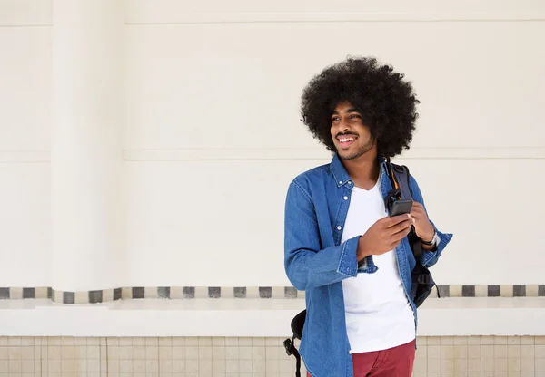 Cool black guy with afro standing isolated white background — Stock Photo, Image