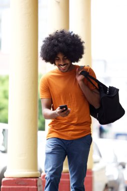 Mutlu adam cep telefonu şehir bakarak bir çanta