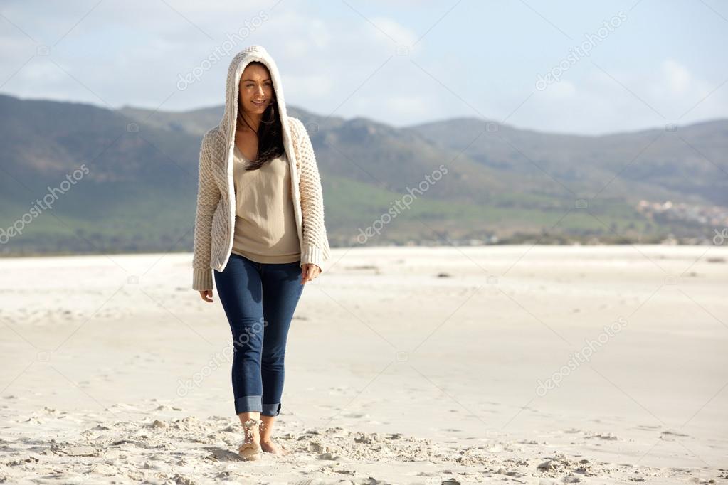 Young woman walking at the beach