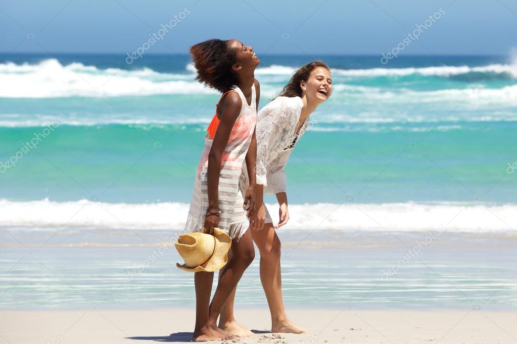 Two barefoot friends enjoying the beach