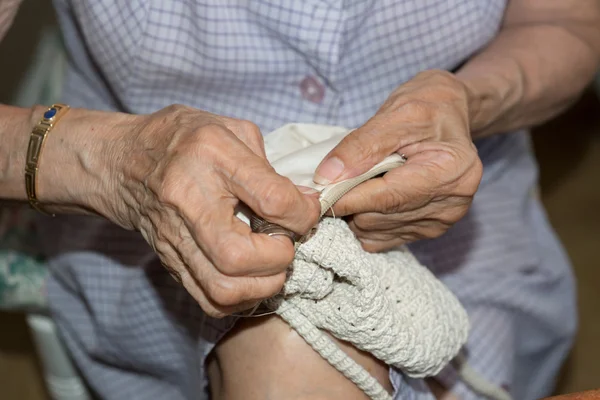 Dressmaker weaving a cushion — Stock Photo, Image