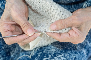 Yaşlı crocheting eller
