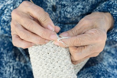 Yaşlı crocheting eller