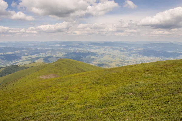 Green mountains and blue cloudy sky — Stock Photo, Image