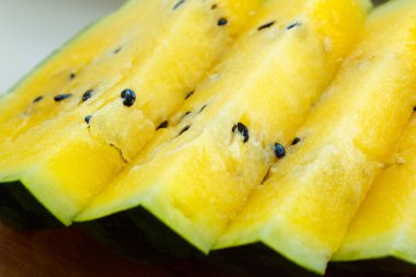 İçinde sarı posa ve siyah tohumlar olan birkaç dilim karpuz..