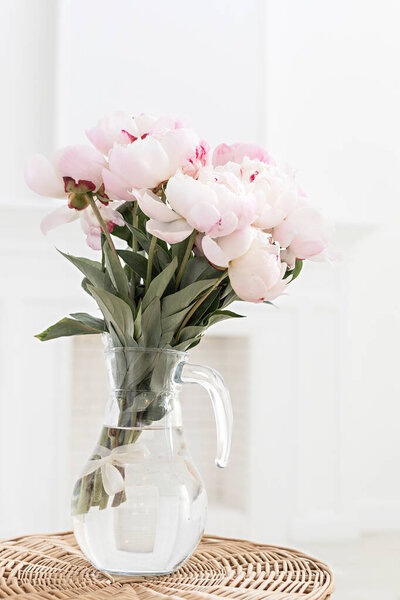 Spring bouquet with pink tulips on scandinavian interior.