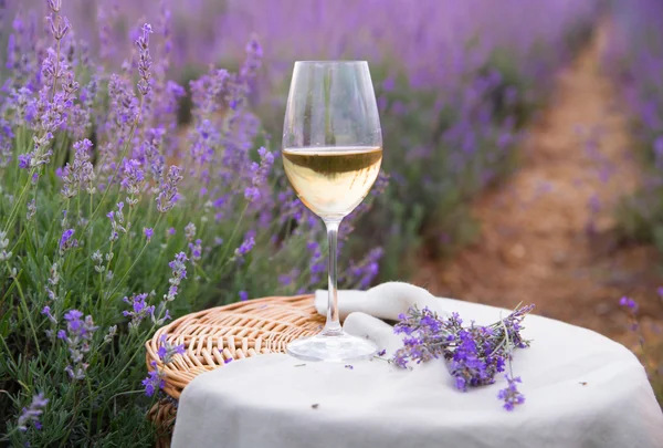 Wine glass against lavender. — Stock Photo, Image