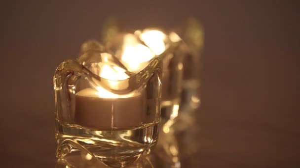 Three burning e-candle in a crystal candle holder — Stock Video