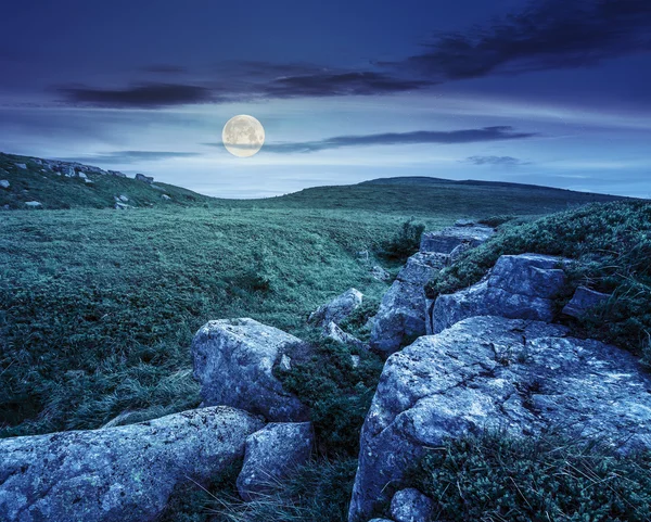 stones in valley on top of mountain range  at night