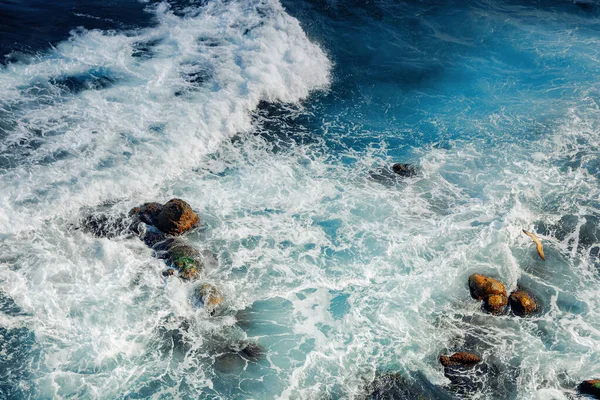 粉碎海浪纹理 从上方俯瞰美丽的自然景观 令人难以置信的蓝色的水 泡沫中的岩石很少 — 图库照片