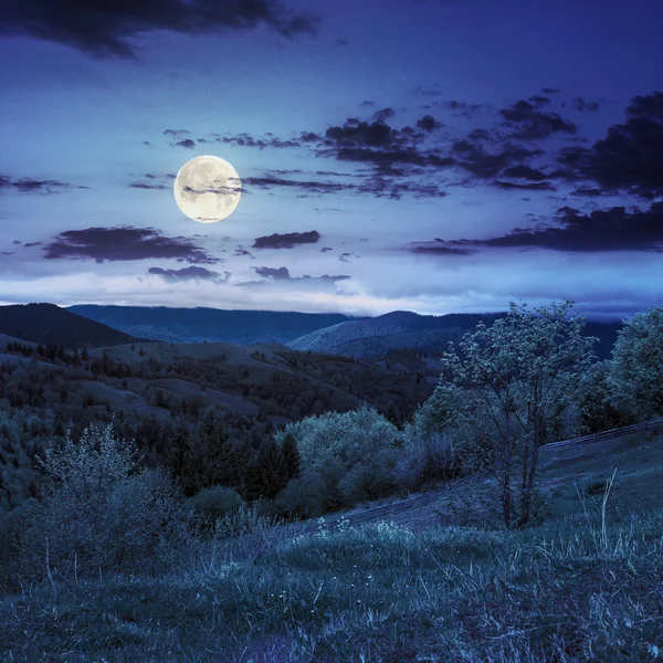 Забор на склоне холма луг в горах ночью — стоковое фото