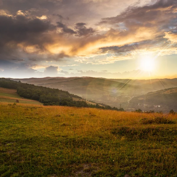 field in mountain near home at sunset