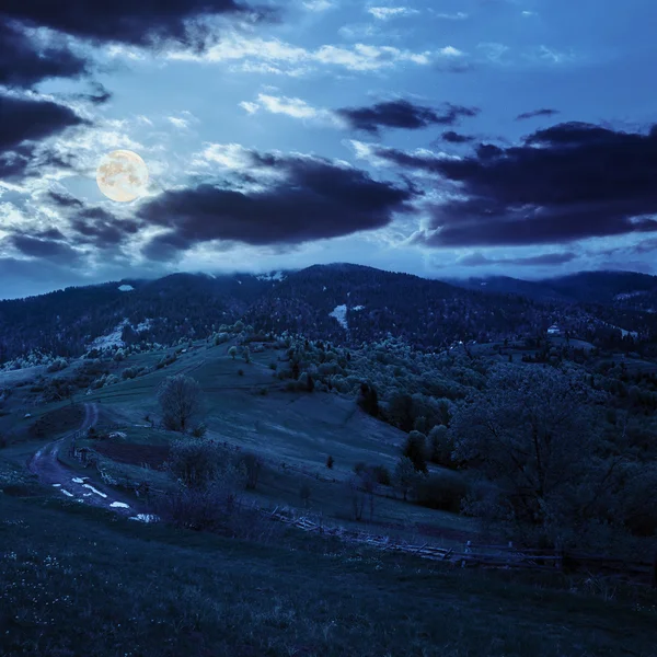 Fence on hillside meadow in mountain at night — Stock Photo, Image