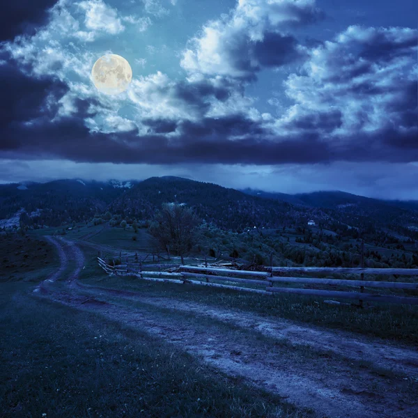 Fence on hillside meadow in mountain at night — Stock Photo, Image