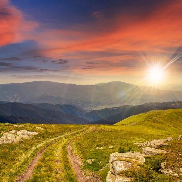 Road among stones on the hillside at sunset — Stock Photo, Image