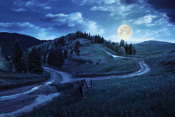 Cross road on hillside meadow in mountain at night — Stock Photo, Image