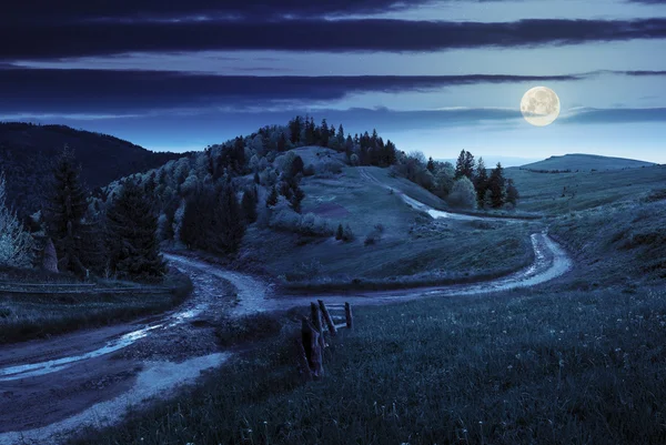 Cross road on hillside meadow in mountain at night — Stock Photo, Image