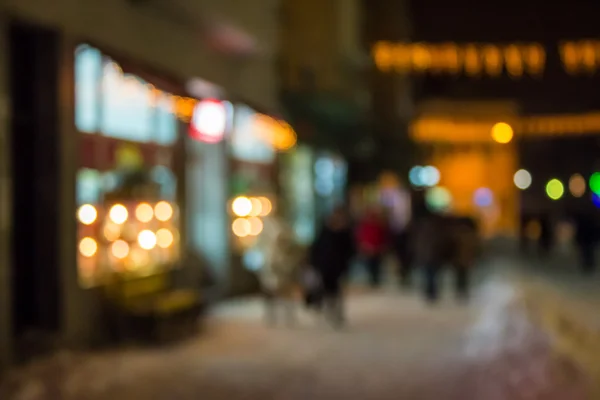 People moving on old city winter night street blurred — Stock Photo, Image