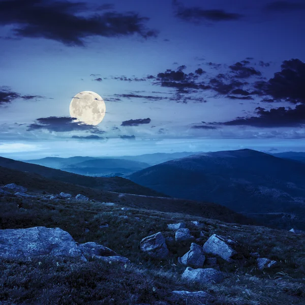 Mountain hillside with white boulders at night — Stock Photo, Image