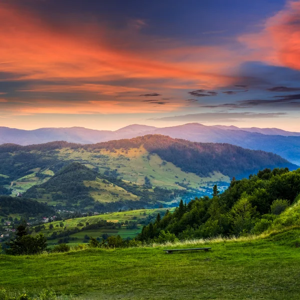 Village near forest in high mountains at sunrise Stock Photo