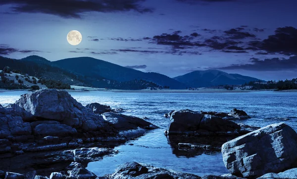 Lake with boulders in mountains at night — Stock Photo, Image