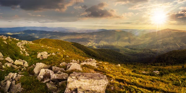 Stones in valley on top of mountain range at sunset — Stock Photo, Image