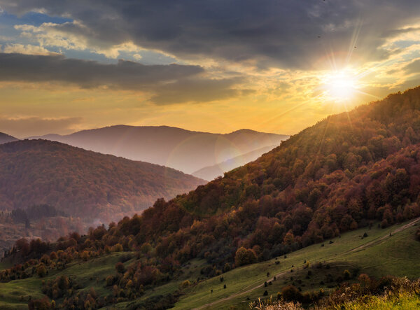 fog around the mountain top at sunset