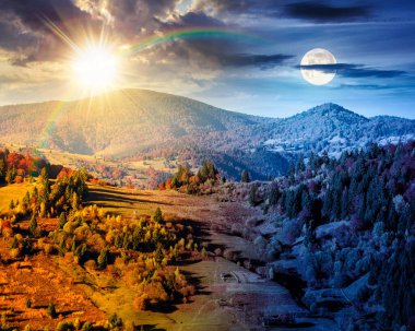 rural area in mountains autumn landscape. day and night time change concept. beautiful countryside scenery with rolling hills under blue sky with sun and moon at twilight. equality and shift template
