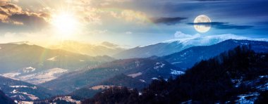 panorama of rolling hills and mountain ridge with snow cowered tops. day and night time change concept. beautiful landscape in springtime cold weather with sun and moon. equality and shift template