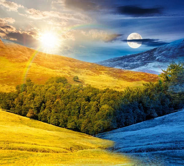 Yaz gündönümünde tepedeki kayın ormanı. Gündüz ve gece zaman kavramını değiştirir. Alacakaranlıkta güneş ve ay ile mavi gökyüzünün altında dağlar. İkilik ve geçiş şablonu için güzel arkaplan