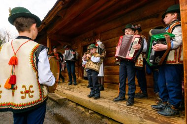 Uzhorod, Ukrayna - 13 Ocak 2018: Hutsuls dışarıda noel şarkıları söylüyor. Kış tatili boyunca halk müziği festivali. Fesleğen Geleneksel kapanış yapan bir grup çocuk eğleniyor.