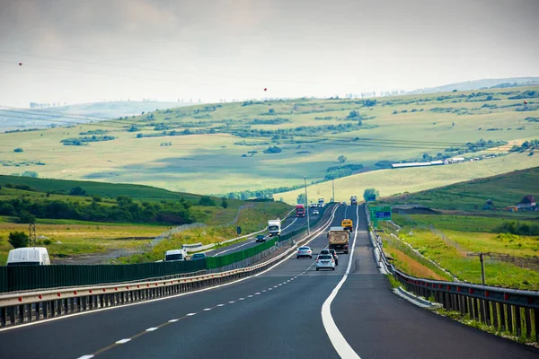 Cluj, Romanya - 27 Haziran 2017: Romanya otoyolunda arabalar. Dağa giden asfalt yol. Uçsuz bucaksız yaz manzarası. Avrupa 'nın ulaşım geçmişi. Güneşli bir günde resimli otoyol duvar kağıdı