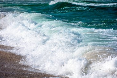 Dinamik dalga öğleden sonra kumlu plajı vurur. takvim ya da kart arkaplanı için telefoto yakın çekim. İspanya 'nın Zosopol rıhtımında el değmemiş bir yer. Akdeniz ikliminde dinlenme